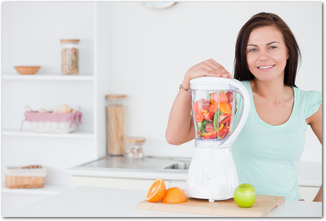 Dark-haired woman posing with a blender