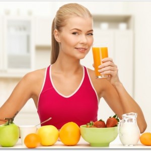 smiling young woman eating healthy breakfast