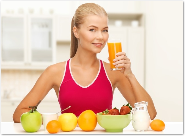 smiling young woman eating healthy breakfast