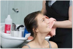 brunette in salon hair getting her hair dryied with a towel